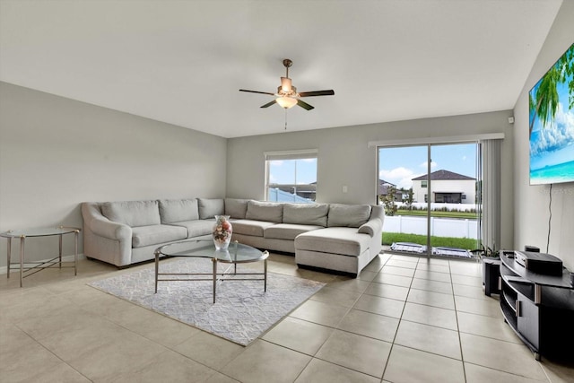 living room with ceiling fan and light tile patterned floors