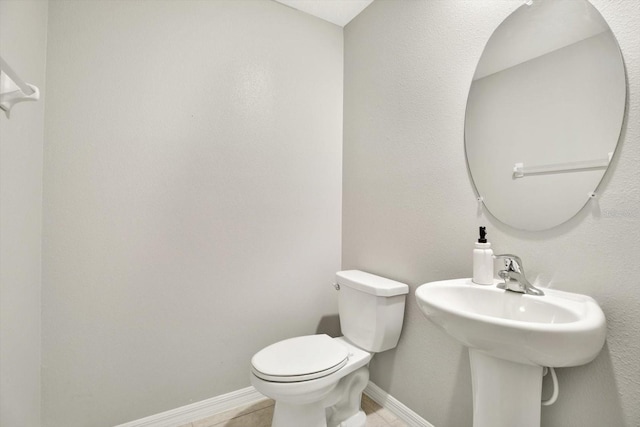 bathroom with tile patterned floors and toilet