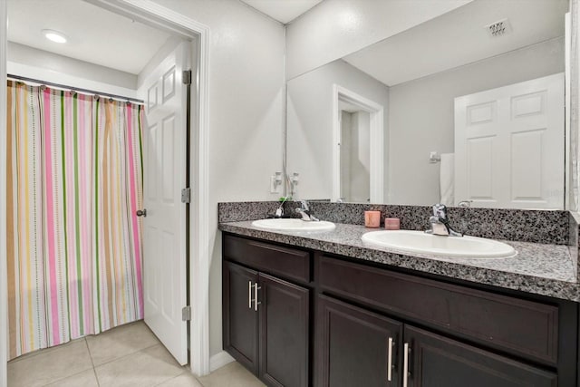 bathroom featuring tile patterned flooring and vanity