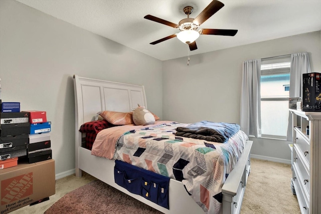 bedroom with ceiling fan and light colored carpet