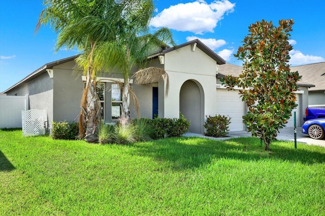 view of front of home featuring a garage and a front lawn