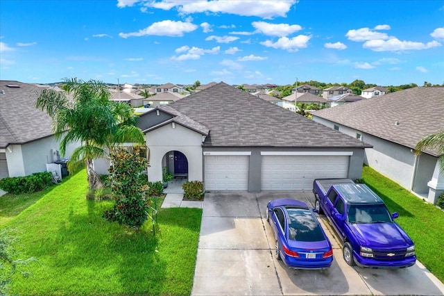 ranch-style house featuring a garage and a front lawn