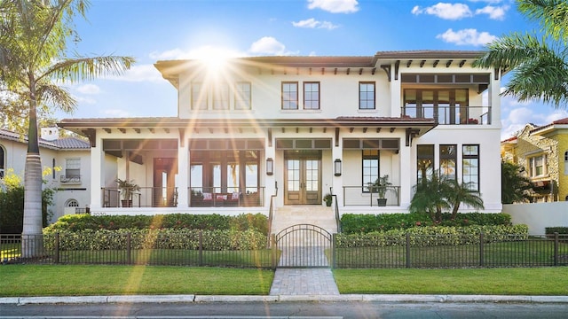 mediterranean / spanish house with a balcony and a front yard