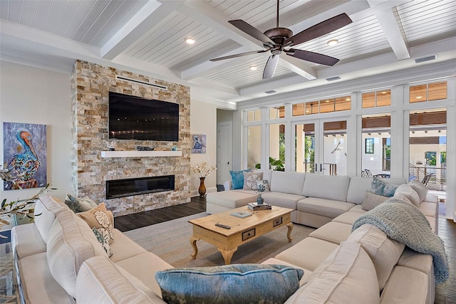 living room featuring wood-type flooring, beamed ceiling, a fireplace, wooden ceiling, and french doors