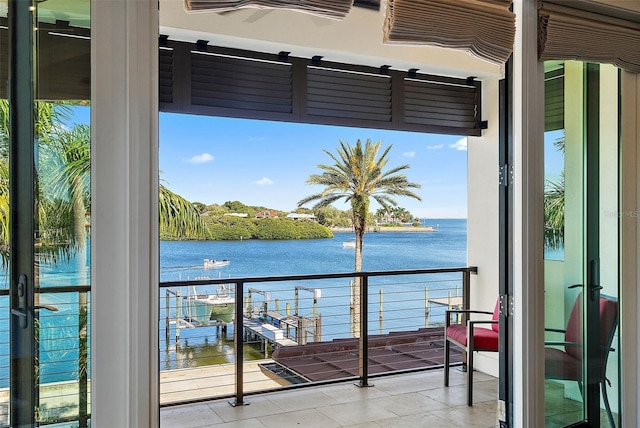 balcony with a water view and ceiling fan