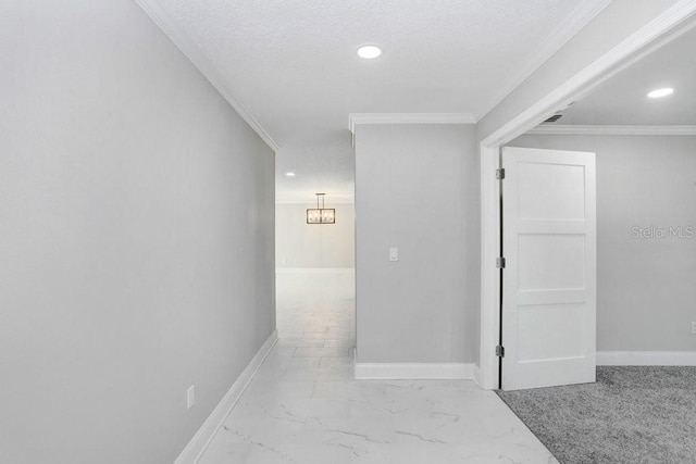 hallway featuring a textured ceiling and crown molding