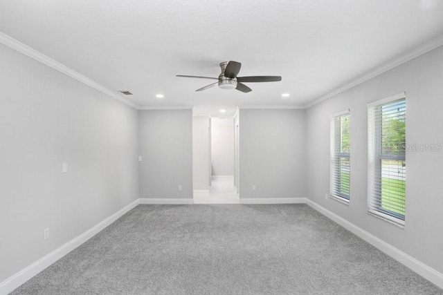 carpeted empty room featuring ornamental molding and ceiling fan