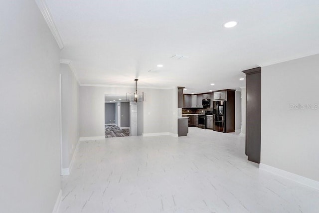 unfurnished living room featuring a chandelier and crown molding