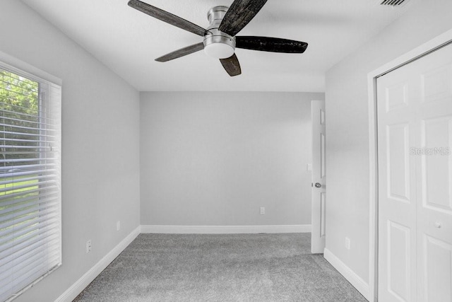 unfurnished room featuring light carpet and ceiling fan