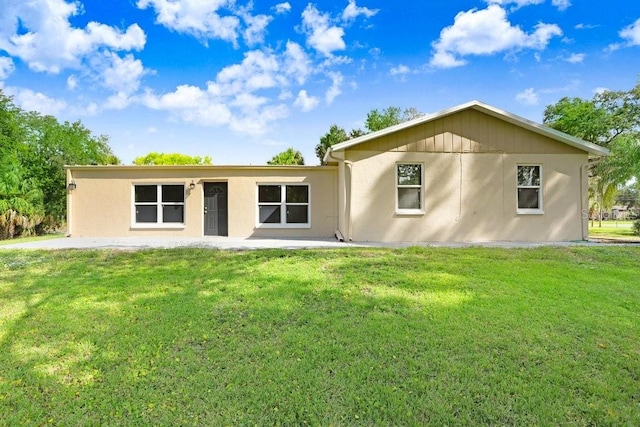 back of house featuring a patio and a yard