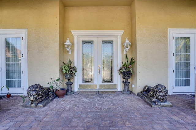 entrance to property featuring a patio area and french doors