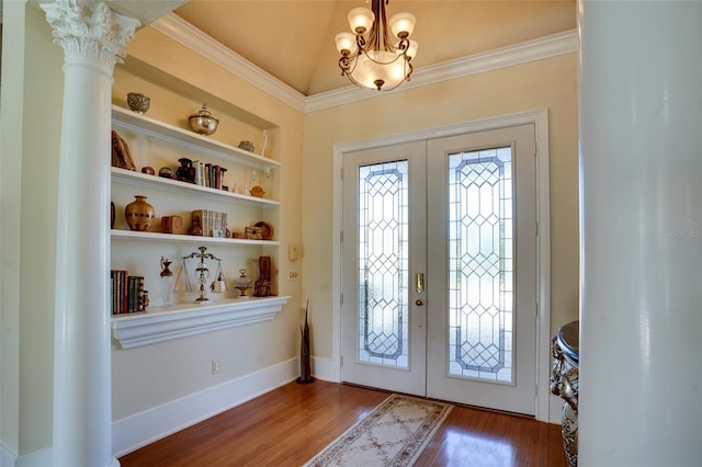 entryway with wood-type flooring, lofted ceiling, a chandelier, crown molding, and french doors