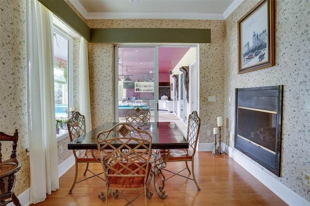 dining space with crown molding and hardwood / wood-style flooring