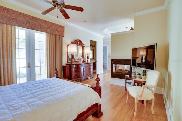 bedroom featuring a multi sided fireplace, crown molding, ceiling fan, and light hardwood / wood-style floors