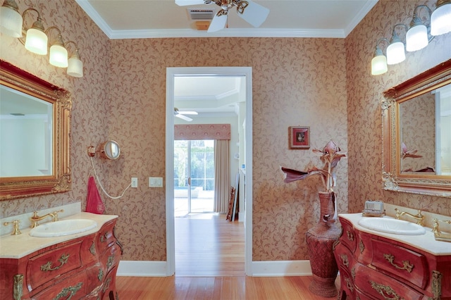 bathroom with hardwood / wood-style flooring, ceiling fan, ornamental molding, and vanity