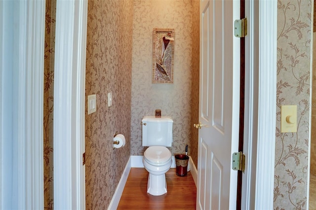 bathroom featuring hardwood / wood-style floors and toilet