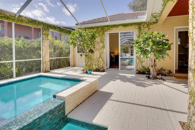 view of swimming pool with glass enclosure and a patio area