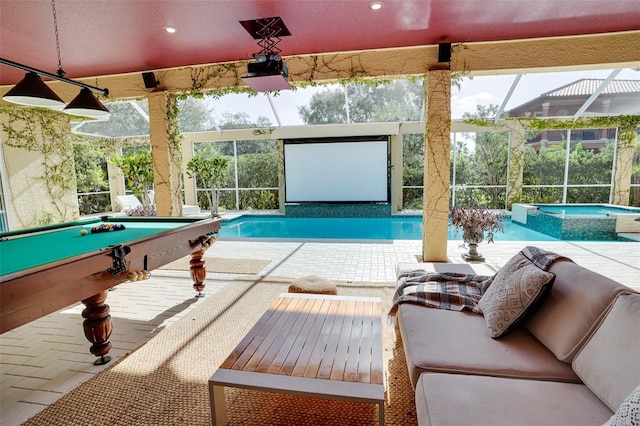 view of pool with a lanai, a patio area, and an in ground hot tub