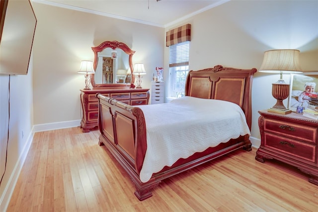 bedroom featuring ornamental molding and light hardwood / wood-style floors