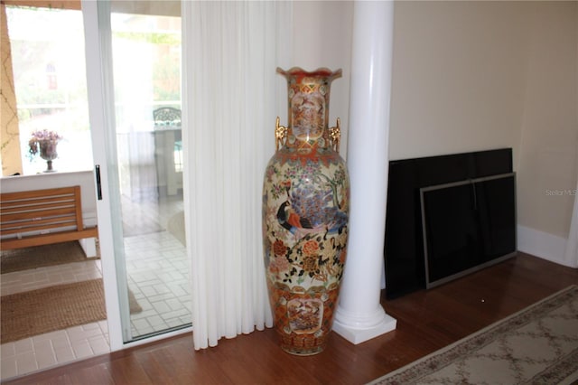 room details featuring wood-type flooring and ornate columns