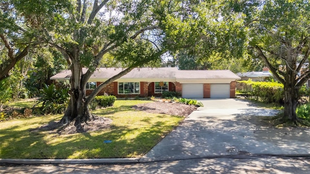 view of front of house with a garage and a front lawn