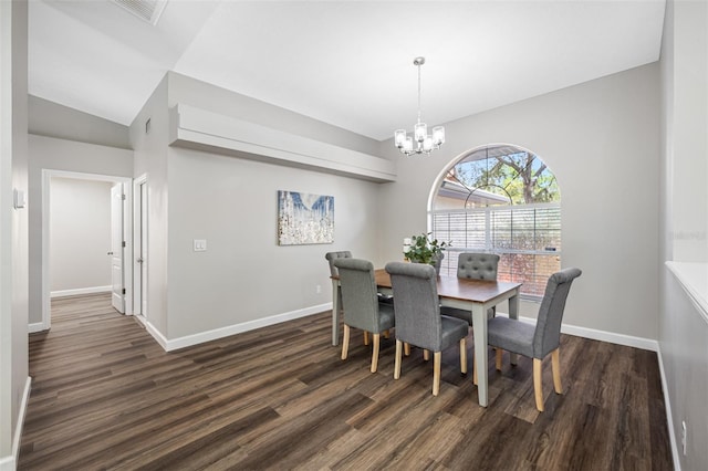 dining space featuring lofted ceiling, dark hardwood / wood-style floors, and an inviting chandelier