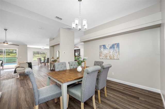 dining area with lofted ceiling, dark hardwood / wood-style floors, and ceiling fan with notable chandelier