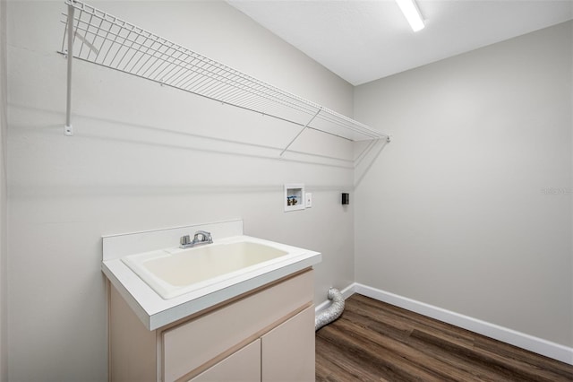 washroom with electric dryer hookup, washer hookup, dark wood-type flooring, sink, and cabinets