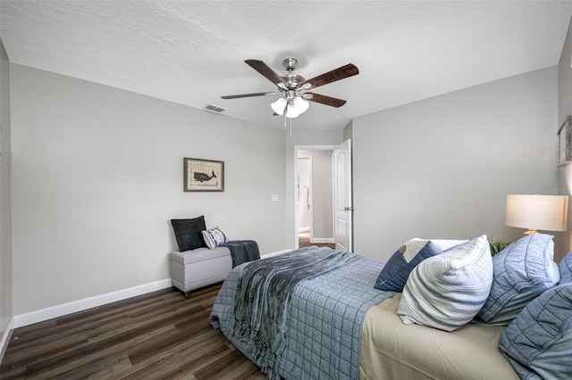 bedroom featuring ceiling fan, a textured ceiling, and dark hardwood / wood-style flooring