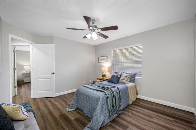 bedroom with dark hardwood / wood-style flooring, a textured ceiling, and ceiling fan