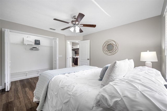 bedroom featuring a closet, dark wood-type flooring, and ceiling fan