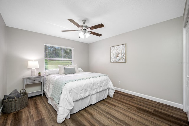 bedroom with dark wood-type flooring and ceiling fan