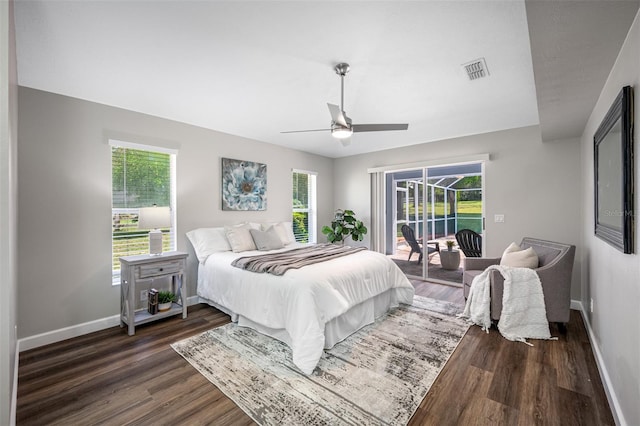 bedroom with dark hardwood / wood-style flooring, access to outside, multiple windows, and ceiling fan