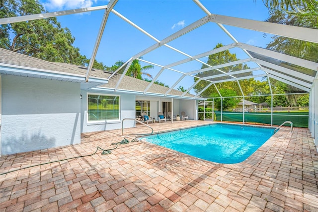 view of pool with a patio area and a lanai