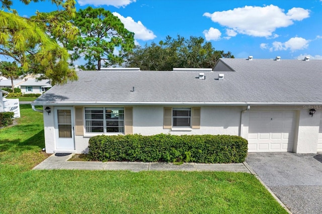 view of front of home with a garage and a front lawn