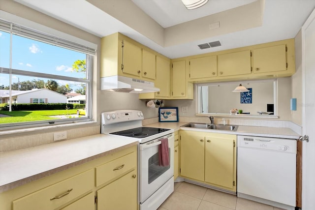 kitchen with white appliances, light tile patterned floors, and sink