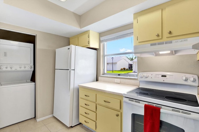 kitchen with white appliances, cream cabinets, stacked washer / drying machine, and light tile patterned floors