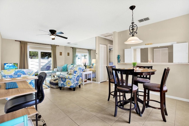 tiled dining room with ceiling fan