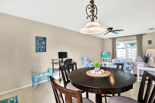 dining space with ceiling fan and light tile patterned floors