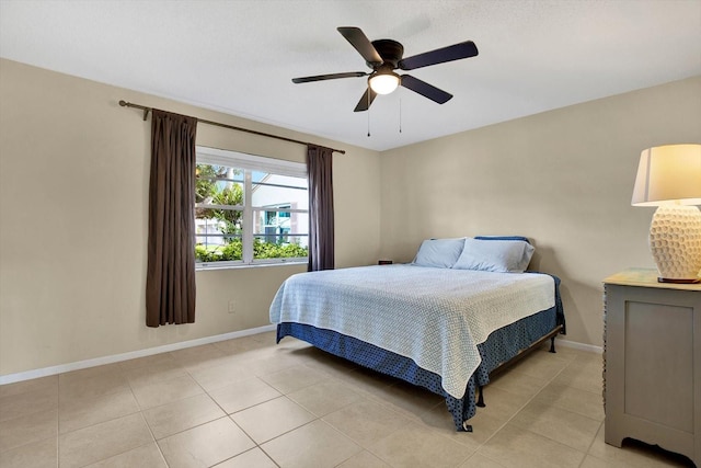 bedroom with ceiling fan and light tile patterned floors