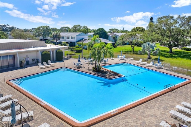 view of pool featuring a lawn and a patio