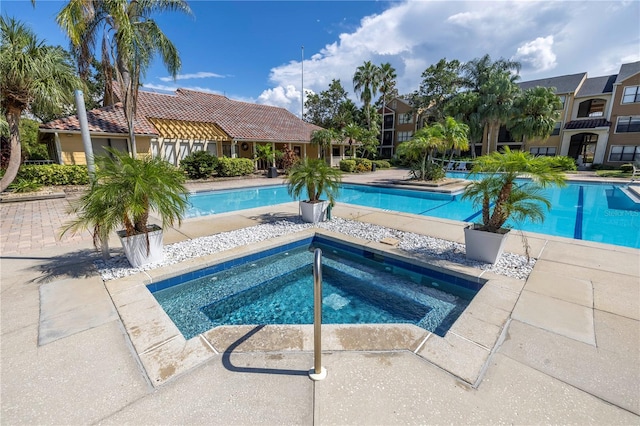 view of swimming pool featuring a community hot tub