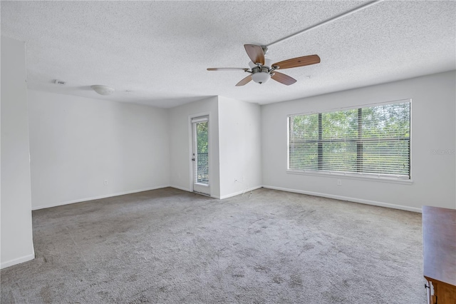 carpeted empty room featuring a textured ceiling and ceiling fan