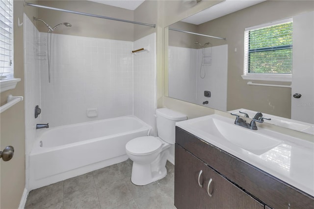 full bathroom featuring vanity, tiled shower / bath combo, toilet, and tile patterned flooring