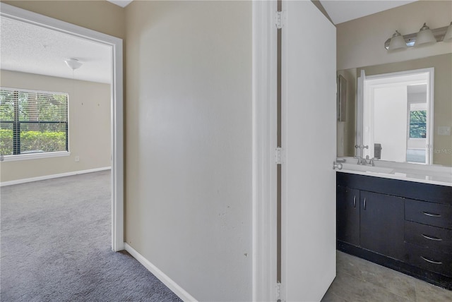 bathroom featuring a textured ceiling and vanity