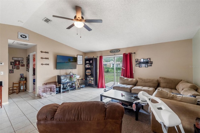 tiled living room featuring ceiling fan, a textured ceiling, and lofted ceiling