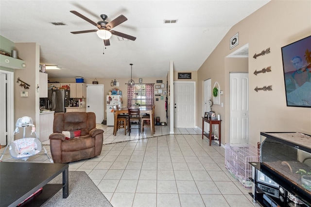 tiled living room with ceiling fan and lofted ceiling