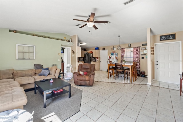 tiled living room featuring ceiling fan and lofted ceiling