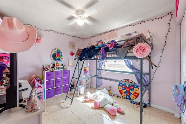 tiled bedroom with ceiling fan and a textured ceiling