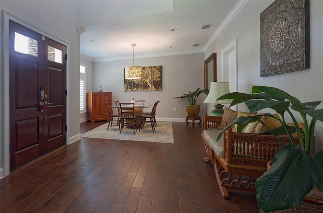 entrance foyer featuring ornamental molding and dark hardwood / wood-style flooring